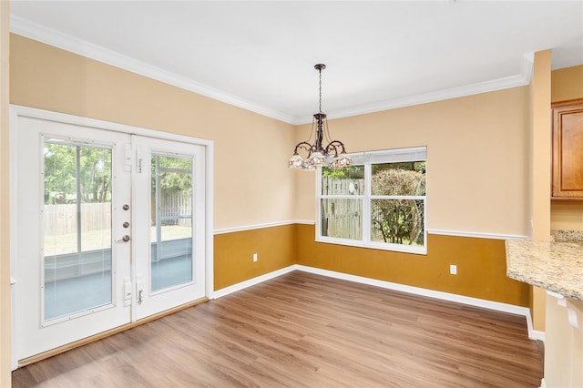 3664 NW 55th Ln, Gainesville, FL 32653 - unfurnished dining area featuring a chandelier, light wood finished floors, baseboards, and crown molding