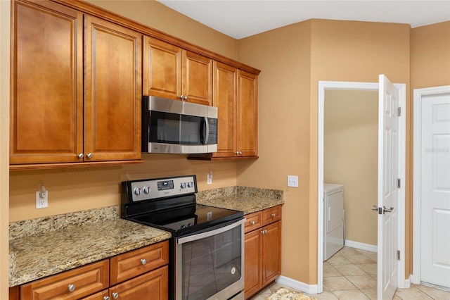 3664 NW 55th Ln, Gainesville, FL 32653 - kitchen featuring stainless steel appliances, brown cabinets, and light stone counters