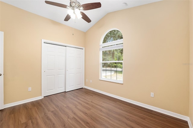 3664 NW 55th Ln, Gainesville, FL 32653 - unfurnished bedroom with wood finished floors, baseboards, lofted ceiling, a closet, and a ceiling fan