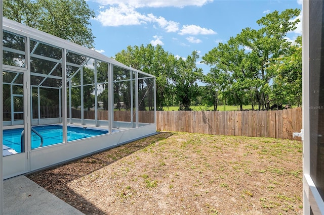 3664 NW 55th Ln, Gainesville, FL 32653 - fenced backyard featuring glass enclosure and a patio