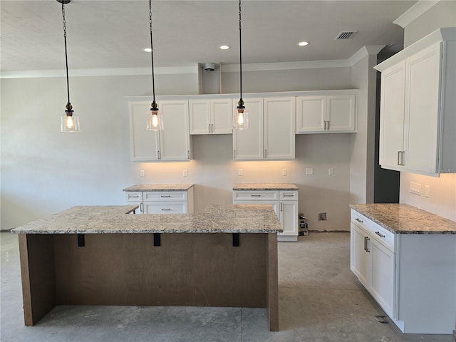 kitchen featuring white cabinetry, crown molding, an island with sink, a breakfast bar area, and hanging light fixtures
