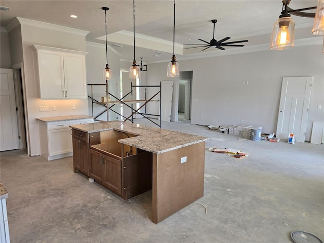 kitchen featuring concrete floors, crown molding, a ceiling fan, pendant lighting, and white cabinets