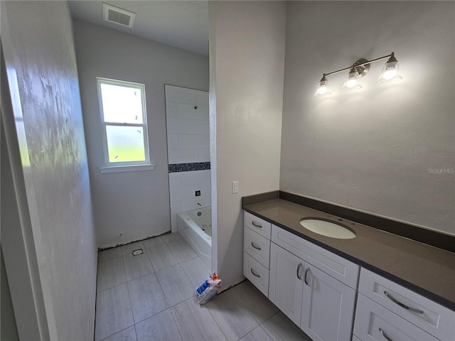 bathroom featuring tile patterned flooring and vanity