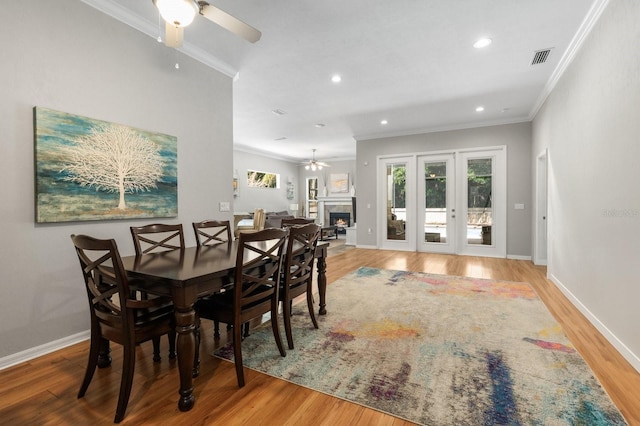dining room with ornamental molding, wood finished floors, ceiling fan, recessed lighting, and baseboards