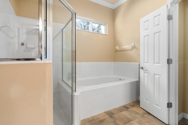 bathroom with a stall shower, a bath, ornamental molding, and tile patterned flooring
