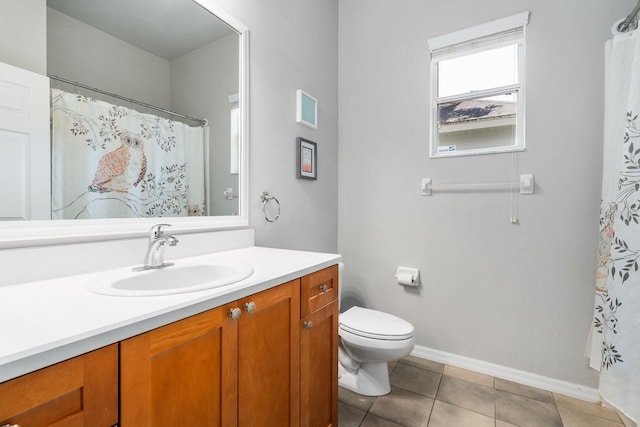 full bathroom featuring toilet, vanity, baseboards, and tile patterned floors