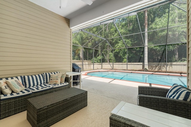 view of swimming pool with a patio, a ceiling fan, outdoor lounge area, and a lanai