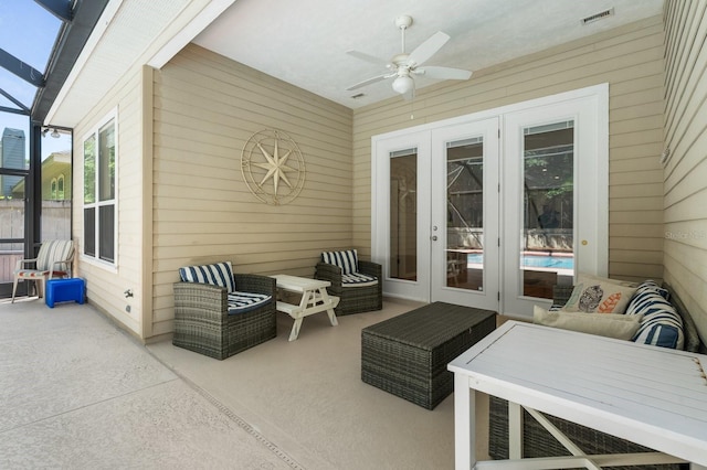 sunroom featuring french doors, an outdoor living space, and ceiling fan
