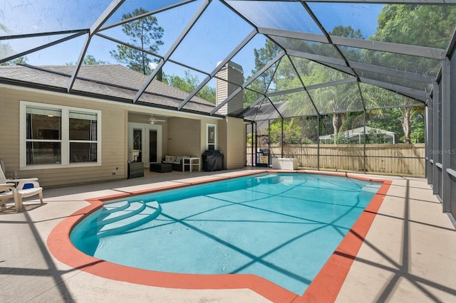 view of swimming pool featuring a patio area, an outdoor hangout area, ceiling fan, and glass enclosure