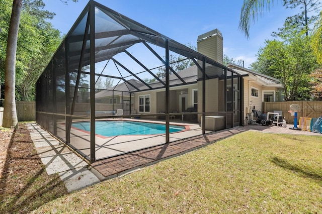 view of pool with a patio area and glass enclosure
