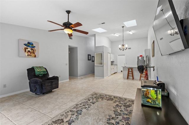 living area featuring a skylight, a chandelier, a ceiling fan, and baseboards