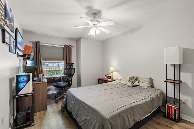 bedroom featuring wood finished floors and a ceiling fan