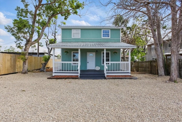 203 1st Ave SE, Steinhatchee, FL 32359 - view of front facade with a porch, fence, and metal roof