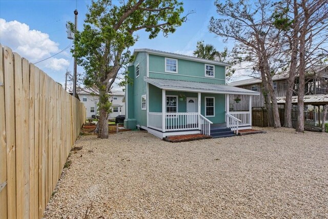 203 1st Ave SE, Steinhatchee, FL 32359 - view of front of house with a porch and fence