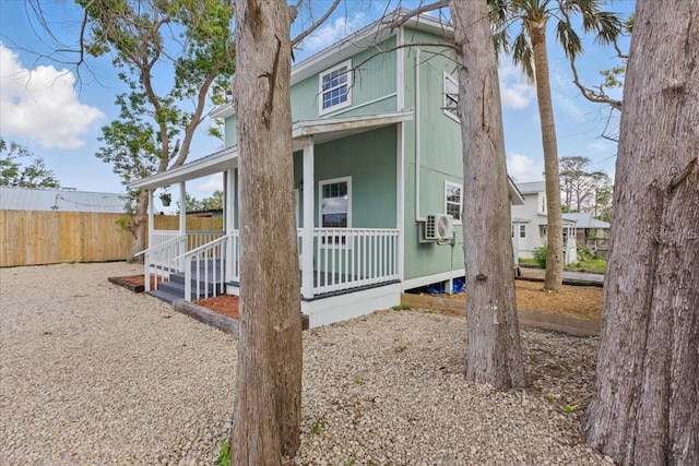203 1st Ave SE, Steinhatchee, FL 32359 - view of side of home with a porch and fence