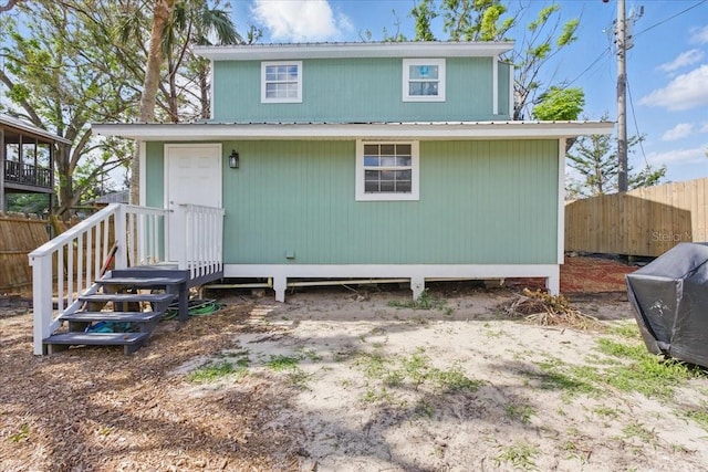 203 1st Ave SE, Steinhatchee, FL 32359 - rear view of house featuring fence and metal roof