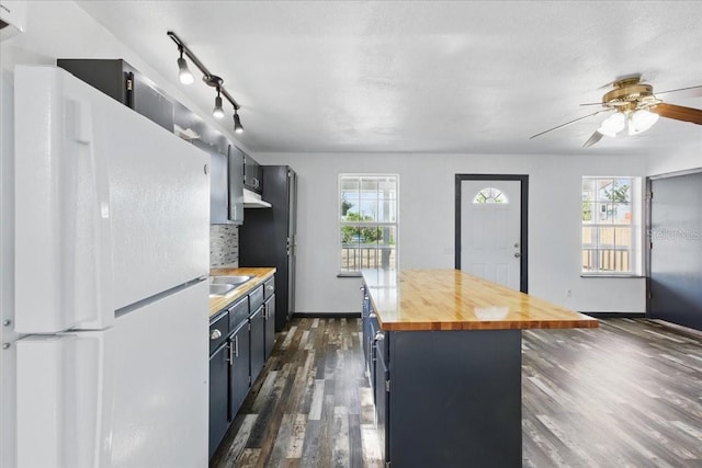 203 1st Ave SE, Steinhatchee, FL 32359 - kitchen with freestanding refrigerator, wood counters, dark wood-type flooring, a ceiling fan, and a center island