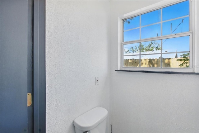 203 1st Ave SE, Steinhatchee, FL 32359 - bathroom featuring a textured wall and toilet