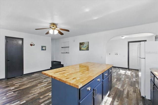 203 1st Ave SE, Steinhatchee, FL 32359 - kitchen featuring blue cabinets, freestanding refrigerator, arched walkways, and butcher block countertops