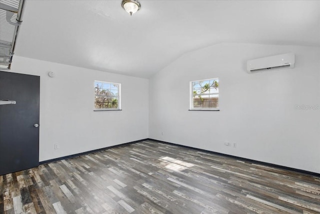 203 1st Ave SE, Steinhatchee, FL 32359 - bonus room featuring a wall mounted air conditioner, vaulted ceiling, wood finished floors, plenty of natural light, and baseboards