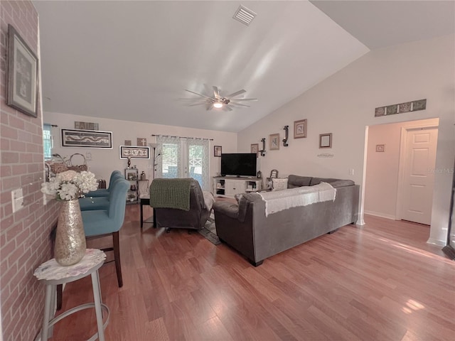 609 NE 2nd St, Williston, FL 32696 - living area featuring vaulted ceiling, light wood-type flooring, a ceiling fan, and baseboards
