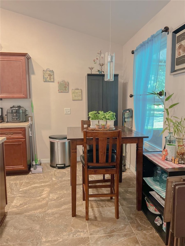 609 NE 2nd St, Williston, FL 32696 - dining room with lofted ceiling and baseboards