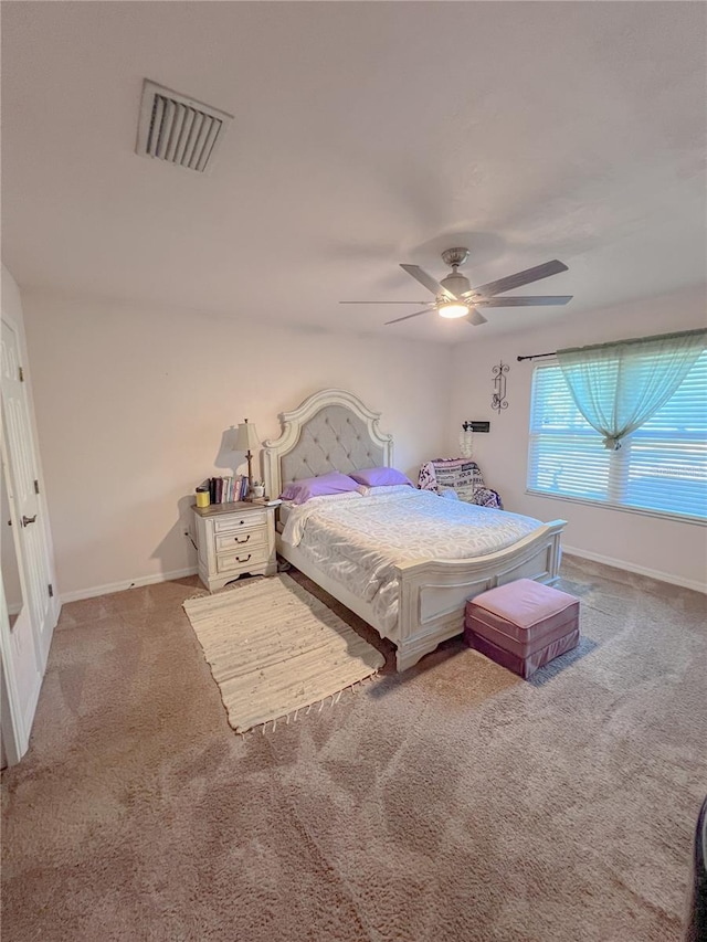 609 NE 2nd St, Williston, FL 32696 - carpeted bedroom with ceiling fan and baseboards