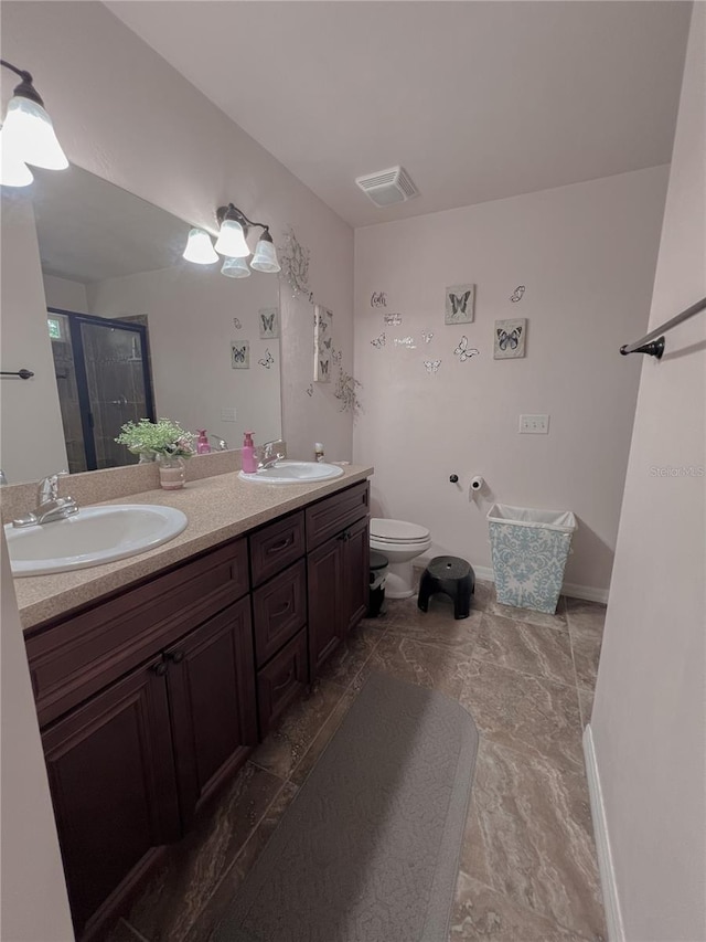609 NE 2nd St, Williston, FL 32696 - full bathroom featuring double vanity, a shower stall, toilet, and baseboards