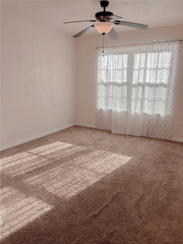 609 NE 2nd St, Williston, FL 32696 - empty room featuring healthy amount of natural light, ceiling fan, light colored carpet, and baseboards