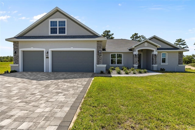 17781 SW 72nd Street Rd, Dunnellon, FL 34432 - view of front of house featuring stucco siding, decorative driveway, a front yard, a garage, and stone siding