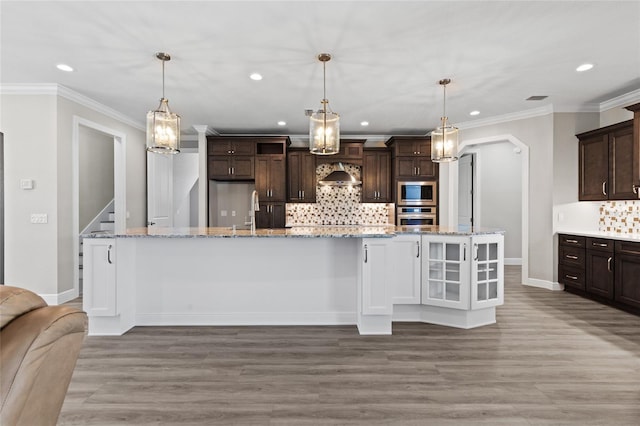 17781 SW 72nd Street Rd, Dunnellon, FL 34432 - kitchen featuring stainless steel appliances, recessed lighting, dark brown cabinets, tasteful backsplash, and ornamental molding