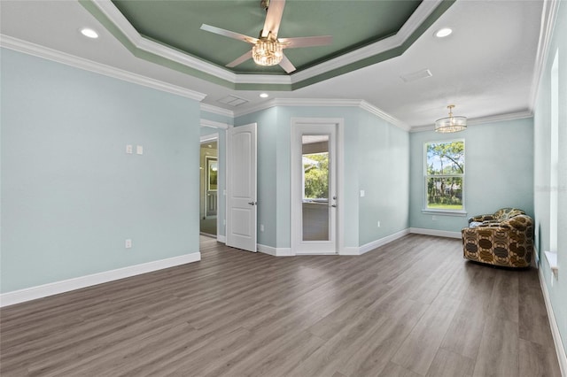 17781 SW 72nd Street Rd, Dunnellon, FL 34432 - empty room featuring a tray ceiling, wood finished floors, ornamental molding, recessed lighting, and ceiling fan