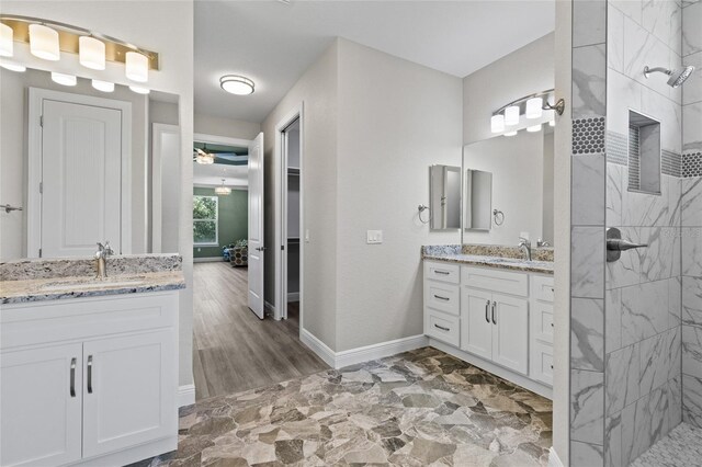 17781 SW 72nd Street Rd, Dunnellon, FL 34432 - full bath featuring two vanities, a tile shower, and ceiling fan
