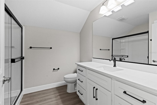 17781 SW 72nd Street Rd, Dunnellon, FL 34432 - bathroom featuring lofted ceiling, a shower stall, wood finished floors, and vanity