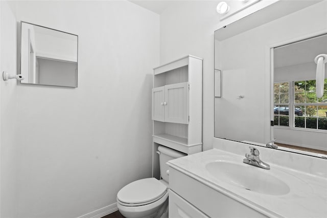 half bath featuring toilet and vanity