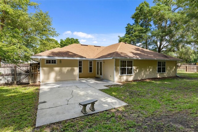 rear view of property featuring a patio and stucco siding