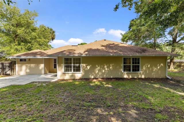view of front facade with a patio, an attached carport, stucco siding, and concrete driveway