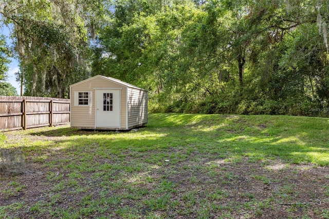 view of yard featuring a storage unit and an outbuilding