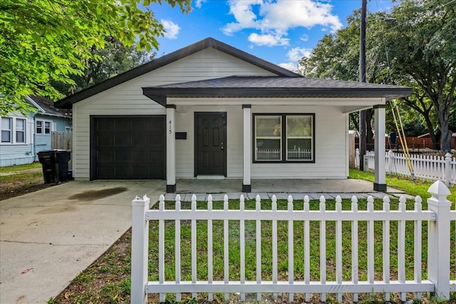 415 NW 10th St, Gainesville, FL 32601 - view of front of property featuring a porch, a fenced front yard, driveway, roof with shingles, and an attached garage