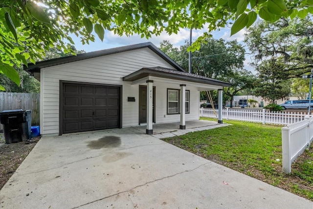 415 NW 10th St, Gainesville, FL 32601 - view of front of home with an attached garage, covered porch, and driveway