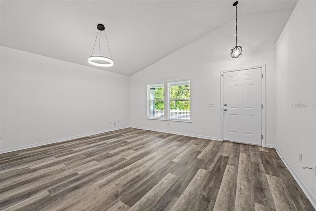 415 NW 10th St, Gainesville, FL 32601 - entryway with wood finished floors, high vaulted ceiling, and baseboards
