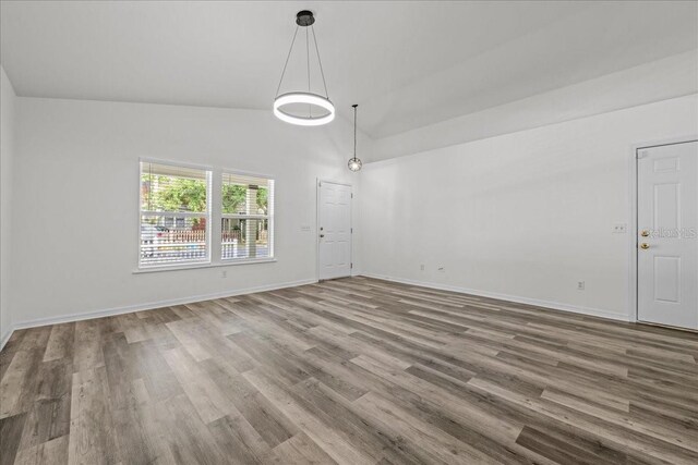 415 NW 10th St, Gainesville, FL 32601 - unfurnished room with wood finished floors, baseboards, and high vaulted ceiling