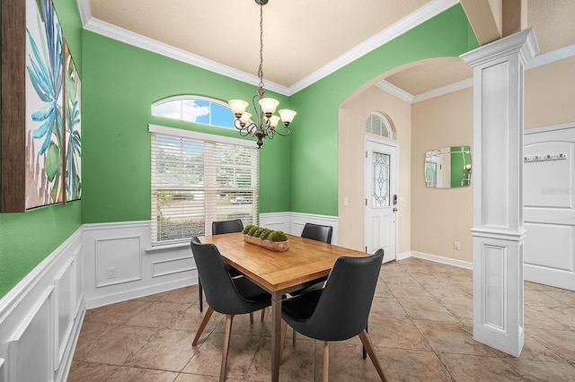 19152 NW 228th Way, High Springs, FL 32643 - dining room with ornate columns, ornamental molding, a chandelier, a wainscoted wall, and arched walkways