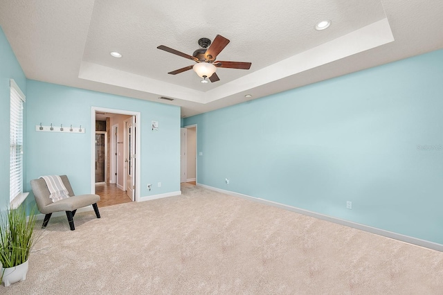 19152 NW 228th Way, High Springs, FL 32643 - unfurnished bedroom with a raised ceiling, light colored carpet, baseboards, a textured ceiling, and ceiling fan