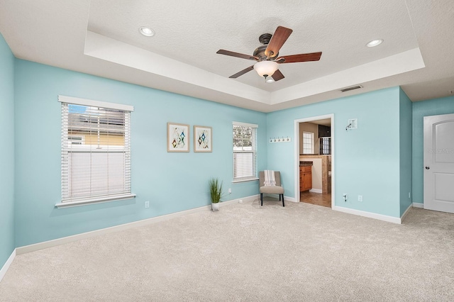19152 NW 228th Way, High Springs, FL 32643 - unfurnished room with a tray ceiling, a ceiling fan, carpet flooring, baseboards, and healthy amount of natural light