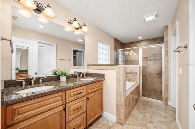 19152 NW 228th Way, High Springs, FL 32643 - bathroom featuring a shower stall, double vanity, a garden tub, and a textured ceiling