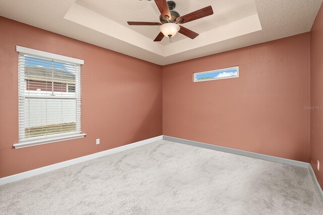 19152 NW 228th Way, High Springs, FL 32643 - empty room with a raised ceiling, baseboards, carpet, and a ceiling fan