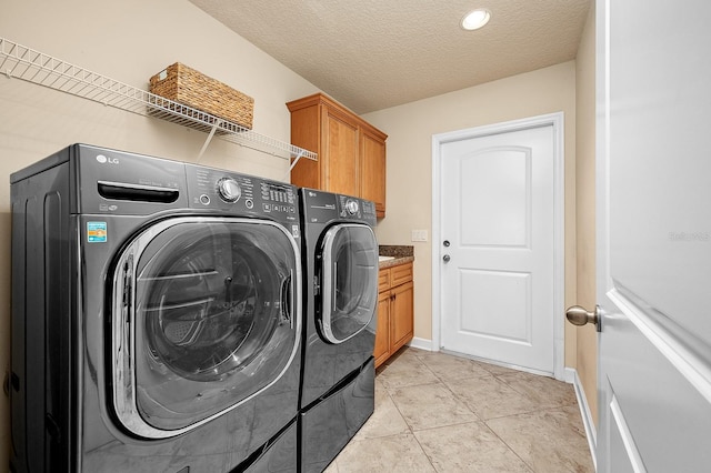 19152 NW 228th Way, High Springs, FL 32643 - laundry room featuring separate washer and dryer, baseboards, cabinet space, a textured ceiling, and light tile patterned floors