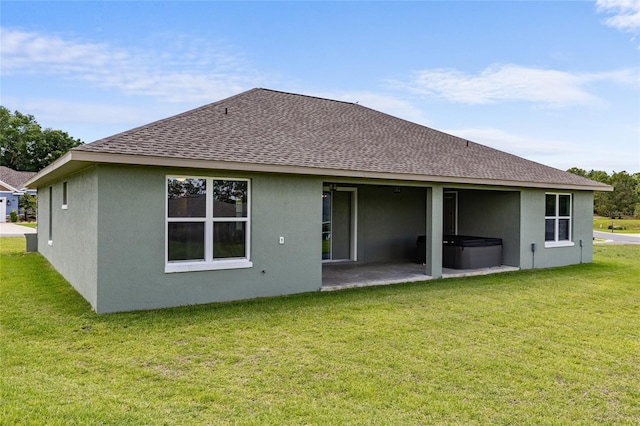 17887 SW 72nd Street Rd, Dunnellon, FL 34432 - rear view of house with a hot tub, roof with shingles, a patio area, and stucco siding