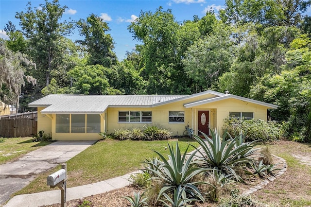 4023 SW 19th St, Gainesville, FL 32608 - view of front of home featuring concrete driveway, metal roof, and concrete block siding